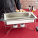 An American Metalcraft stainless steel water pan in a rectangular chafer on a table.