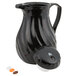 A black Vollrath SwirlServe beverage server with a lid and a spout.