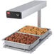 A Hatco heated shelf with trays of meatballs and other food on it.