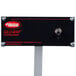 A black rectangular Hatco food warmer with a white rectangular sign and red and black text.