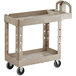 A beige Rubbermaid plastic utility cart with two shelves and wheels.