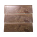 A rectangular faux walnut wood riser with a wood panel surface.