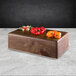 A rectangular faux walnut melamine modular riser with peppers on it.