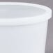 A 2 quart translucent plastic deli container with a lid.