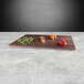 An Elite Global Solutions rectangular faux walnut melamine serving board with different vegetables on it.