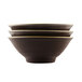 Elite Global Solutions Pebble Creek tapenade-colored bowls with a black surface and white border stacked on a white background.