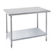 An Advance Tabco stainless steel work table with a galvanized steel shelf.