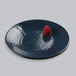 An Elite Global Solutions lapis-colored round plate with a strawberry on it.