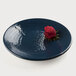 A blue Elite Global Solutions Pebble Creek plate with a red rose with black dots on it.