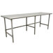 A stainless steel Advance Tabco work table with metal legs.