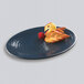 An Elite Global Solutions lapis-colored oval platter with fruit on it.