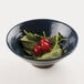 An Elite Global Solutions Pebble Creek lapis-colored melamine bowl filled with cherry tomatoes and spinach.