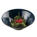 An Elite Global Solutions lapis-colored melamine bowl filled with spinach and tomatoes.
