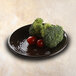 An Elite Global Solutions Pebble Creek aubergine-colored melamine plate with a bowl of broccoli and tomatoes on it.