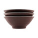 Three Elite Global Solutions Abyss-colored melamine bowls with black and brown designs stacked on top of each other.