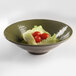 An Elite Global Solutions melamine bowl filled with lettuce and tomatoes.