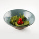 An Elite Global Solutions Pebble Creek Abyss-colored melamine bowl filled with spinach and tomatoes.