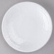 A white Elite Global Solutions Pebble Creek round melamine plate with a small hole in the center.