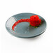 Abyss-colored melamine plate with a strawberry rose made with red sauce.