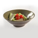 A Lizard-colored Elite Global Solutions melamine bowl filled with lettuce and tomatoes.