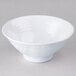 A white Elite Global Solutions Pebble Creek bowl with a white rim on a gray surface.