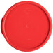 A red Carlisle round polypropylene food storage container lid.