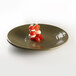 An Elite Global Solutions Pebble Creek lizard-colored melamine plate with food on it.