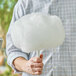 A man holding a large cotton candy cone with Great Western Mint Green Cotton Candy.