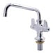 A silver Equip by T&S deck mount faucet with lever handles and a swing nozzle.