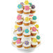 A Wilton 4-tier collapsible dessert display stand with cupcakes on it. The cupcakes have flowers on top.