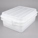 A white plastic Vollrath food storage container with a lid.