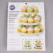 A package of yellow cupcakes on a white Wilton 3-tier cupcake stand.