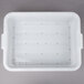 A white plastic Vollrath Color-Mate drain box with holes in the bottom.