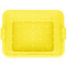 A yellow plastic Vollrath Color-Mate drain box with holes.