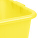 A close-up of a yellow plastic container with a white lid.