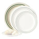 A stack of Emerald green and white striped GET melamine plates with a croissant on one plate.