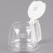 A clear glass Proctor Silex coffee carafe with a white handle and lid.