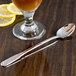 Oneida Cityscape stainless steel spoon next to a glass of lemonade with a lemon slice.