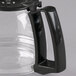 A Proctor Silex black glass coffee pot with a handle.