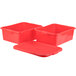 Three red plastic containers with lids on a counter.