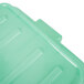 A Vollrath green plastic lid on a green container.
