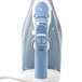 A close-up of a white and blue Hamilton Beach steam iron with a cord.