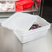A white Vollrath Traex plastic food storage container with lid on a table.
