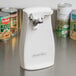 A white Proctor Silex electric can opener on a counter.
