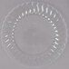 A clear plastic plate with a scalloped edge.