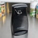 A black Proctor Silex electric can opener on a counter.
