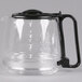 A clear glass Hamilton Beach coffee pot with a black handle.