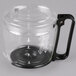 A clear glass container with a black handle and lid.