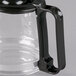 A clear glass Hamilton Beach coffee carafe with a black handle.