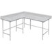 A white L-shaped Advance Tabco commercial work table with metal legs.